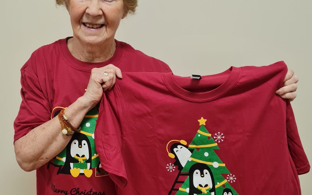 Maggie Celebrates 1 Year Anniversary of World’s 1st Covid-19 Vaccine with New Penguino and Friends T-Shirt